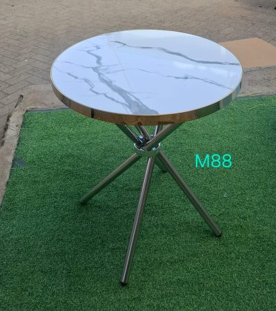 coffee table, modern coffee table, wooden coffee table, glass coffee table, round coffee table, rectangular coffee table, square coffee table, small coffee table, large coffee table, living room coffee table, contemporary coffee table, luxury coffee table, designer coffee table, minimalist coffee table, rustic coffee table, industrial coffee table, metal coffee table, marble coffee table, stone coffee table, ceramic coffee table, solid wood coffee table, vintage coffee table, classic coffee table, farmhouse coffee table, Scandinavian coffee table, mid-century coffee table, modern living room table, home décor coffee table, premium coffee table, high-quality coffee table, stylish coffee table, elegant coffee table, durable coffee table, sturdy coffee table, affordable coffee table, budget coffee table, premium wooden table, natural wood coffee table, engineered wood coffee table, laminated coffee table, tempered glass table, chrome coffee table, steel coffee table, black coffee table, white coffee table, brown coffee table, coffee table Kenya, coffee table Nairobi, living room furniture table, center table, lounge table, sitting room coffee table, modern center table, spacious coffee table, compact coffee table, slim coffee table, multi-level coffee table, double-tier coffee table, shelf coffee table, storage coffee table, lift-top coffee table, hidden-storage coffee table, drawer coffee table, open-shelf coffee table, office coffee table, waiting room coffee table, reception coffee table, hotel lobby coffee table, restaurant coffee table, café coffee table, small space coffee table, apartment coffee table, condo coffee table, entryway coffee table, premium finish coffee table, high-gloss coffee table, matte finish coffee table, sleek coffee table, geometric coffee table, statement coffee table, art-inspired coffee table, sculptural coffee table, handcrafted coffee table, handmade coffee table, artisan coffee table, eco-friendly coffee table, sustainable wood table, durable build coffee table, heat-resistant coffee table, scratch-resistant coffee table, spill-proof coffee table, easy-clean coffee table, versatile coffee table, multipurpose coffee table, reading coffee table, display coffee table, décor centerpiece table, centerpiece coffee table, decorative coffee table, home accent table, luxury living table, modern interior coffee table, interior design coffee table, decorative lounge table, TV room coffee table, entertainment room table, functional coffee table, practical coffee table, family room coffee table, cozy living room table, stylish interior table, chic coffee table, trend-setting coffee table, 2025 modern coffee table, designer-inspired coffee table, premium interior table, ergonomic coffee table, kid-friendly coffee table, pet-friendly coffee table, water-resistant coffee table, stain-resistant coffee table, anti-scratch table, polished surface coffee table, hand-polished coffee table, thick-top coffee table, slim-top coffee table, lightweight coffee table, heavy-duty coffee table, reinforced coffee table, strong frame coffee table, welded-frame coffee table, premium craftsmanship coffee table, imported coffee table, exclusive coffee table, limited edition coffee table, functional modern table, décor-friendly coffee table, curated design table, artisan-made table, home elegance coffee table, hospitality coffee table, commercial-grade coffee table, office lounge coffee table, studio apartment table, penthouse coffee table, luxury suite table, resort coffee table, Airbnb coffee table, furnished apartment table, décor-enhancing coffee table, statement piece coffee table, holiday décor coffee table, festive décor coffee table, multipurpose living room table, indoor coffee table, outdoor coffee table, patio coffee table, balcony coffee table, veranda coffee table, porch coffee table, heavy-top wooden table, rustic reclaimed wood coffee table, barnwood coffee table, live-edge coffee table, log coffee table, natural slab coffee table, tree trunk coffee table, rope coffee table, woven coffee table, rattan coffee table, cane coffee table, bamboo coffee table, boho coffee table, coastal coffee table, beach-style coffee table, nautical coffee table, zen coffee table, Japanese-style coffee table, Korean low table, floor coffee table, low-rise coffee table, high-rise coffee table, adjustable height coffee table, convertible coffee table, foldable coffee table, extendable coffee table, expandable coffee table, nesting coffee table, set of 2 coffee tables, set of 3 coffee tables, paired coffee tables, side-by-side coffee tables, twin coffee tables, modern nesting set, rustic nesting set, geometric nesting table, open-framed coffee table, minimal metal table, iron frame coffee table, bronze coffee table, brass coffee table, gold coffee table, silver coffee table, copper coffee table, brushed metal coffee table, industrial pipe coffee table, distressed finish table, reclaimed wood table, repurposed wood table, art décor coffee table, sculpted base table, tripod coffee table, cross-leg coffee table, U-leg coffee table, X-leg coffee table, curved coffee table, oval coffee table, asymmetric coffee table, abstract coffee table, futuristic coffee table, contemporary sculpted table, coffee tabletop, glass-top coffee table, wooden-top coffee table, stone-top coffee table, textured coffee table, fluted base coffee table, ribbed coffee table, carved wood coffee table, hand-carved table, artisanal wood table, mosaic coffee table, tiled coffee table, patterned top coffee table, printed top coffee table, designer pattern coffee table, soft-edge coffee table, rounded-edge coffee table, child-safe edge coffee table, beveled-edge coffee table, sealed wooden table, varnished coffee table, oil-treated wood table, waxed finish coffee table, polished marble coffee table, veined marble table, granite coffee table, solid stone coffee table, ceramic-tile coffee table, terrazzo coffee table, luxury stone table, heavy stone coffee table, modern elite coffee table, accent furniture coffee table, modern home centerpiece, elegant lounge furniture, cozy living furniture, family-friendly coffee table, office waiting area table, salon coffee table, spa coffee table, boutique coffee table, showroom display table, exhibition coffee table, staging furniture coffee table, home staging center table, décor styling furniture, real estate staging table, modern furnishing coffee table, trending coffee table, timeless design coffee table, contemporary functional table, interior styling coffee table, magazine table, book display table, décor exhibition table, living room organization table, multipurpose furniture, artistic home table, boutique living table, modern luxury piece, modern charm furniture, elegant modern lifestyle table, practical living table, coffee table for small living rooms, coffee table for large living rooms, hi-end coffee table, designer décor coffee table, fine furniture table, customizable coffee table, bespoke coffee table, tailor-made coffee table, handmade artisan table, premium build table, furniture-grade coffee table, thick legs coffee table, slim legs table, tapered leg coffee table, hairpin leg coffee table, metal hairpin coffee table, rustic metal table, Nordic style coffee table, European style coffee table, African crafts coffee table, unique hand-carved table, cultural design coffee table, traditional woodwork table, modern rustic crossover table, industrial chic table, ultra-modern coffee table, futuristic home coffee table, living room anchor piece, artistic base table, functional art coffee table, showcase coffee table, premium decor element, wooden furniture Kenya, home furniture Kenya, living room essentials, living room upgrades, stylish home centerpiece, living room makeover table, hospitality-grade furniture, hotel-quality coffee table, strong hardwood coffee table, acacia wood coffee table, mahogany coffee table, oak coffee table, teak coffee table, mango wood coffee table, rubberwood coffee table, engineered hardwood coffee table, softwood coffee table, pine coffee table, fir wood coffee table, bamboo eco-friendly table, cane woven table, rattan living table, premium craftsmanship furniture, steel-reinforced table, ultra-thick top table, trendy living room centerpiece, conversation-starter coffee table, designer’s pick table, interior decorator table, living space enhancer, everyday living table