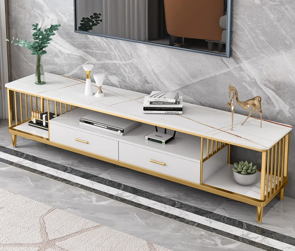 Modern Marble TV Console – Luxury Meets Functionality Enhance your living room with the Modern Marble TV Console, designed to combine elegance, durability, and modern functionality. Its marble finish adds a luxurious statement to any interior. Moreover, the sleek design creates a stylish focal point while keeping your entertainment area organized and clutter-free. Premium Marble Finish and Strong Build This TV console features a high-quality marble or marble-effect tabletop paired with a sturdy metal or engineered wood base. As a result, it offers excellent durability and long-term performance. Additionally, the scratch-resistant and heat-resistant surface ensures the console maintains its refined appearance even with daily use. Spacious and Practical Storage The Modern Marble TV Console provides ample storage for your entertainment essentials. It includes spacious cabinets, drawers, or open shelves for media devices, remote controls, books, and décor items. Furthermore, the wide tabletop comfortably supports flat-screen TVs while leaving room for decorative accents. Stylish and Contemporary Design With its clean lines and elegant marble finish, this TV console complements modern, contemporary, and luxury interiors. Moreover, the neutral tones blend seamlessly with different color schemes and furniture styles. This makes it suitable for living rooms, lounges, apartments, or executive spaces. Cable Management and Convenience Designed with practicality in mind, the console includes built-in cable management openings. These allow you to organize wires neatly and maintain a clean, polished look. In addition, the elevated base makes cleaning underneath easy, improving overall convenience. Easy Assembly and Low Maintenance Assembly is quick and straightforward, with clear instructions and fittings included. In addition, maintenance is effortless. Simply wipe the marble surface with a soft, damp cloth to remove dust or spills. This low-maintenance design saves time while preserving elegance. Why Choose Our Modern Marble TV Console? Luxurious marble finish for a premium look Durable construction for long-term use Spacious storage for media and accessories Built-in cable management for a tidy setup Modern, elegant design for stylish interiors Finally, the Modern Marble TV Console combines luxury, practicality, and durability, making it the perfect entertainment unit for modern homes that value both style and function.